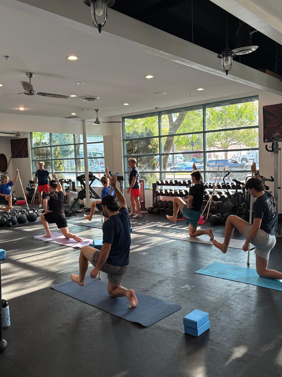 Hockey athletes in a mobility class training hip control